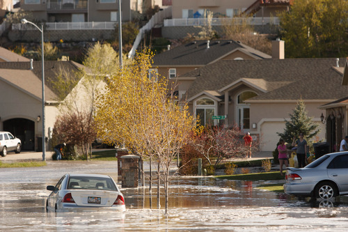 Trent Nelson  |  The Salt Lake Tribune
A canal breach sent water flooding into a Murray neighborhood Saturday, April 27, 2013.