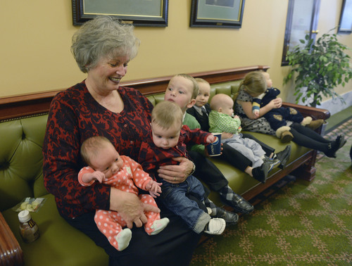 Al Hartmann  |  The Salt Lake Tribune 
Rep. Ronda Menlove, R-Garland, has her arms full getting her grandchildren together for a group photo just outside the house of representatives chambers Friday February 7, 2014. She said that since she has been in the Legislature she has had 10 grandchildren.