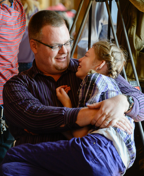 Franciso Kjolseth  |  The Salt Lake Tribune
Marshall Christensen of Provo with his daughter Jessica, 13, as they wait for Governor Gary R. Herbert to sign the Ceremonial bill to legalize the use of nonintoxicating cannabis oil by Utahns with untreatable epilepsy. HB105 now called 'Charlee's Law," will go into effect on July 1 as families Gathered in the Gold Room at the Utah Capitol on Tuesday, March 25, 2014 to celebrate the historical occasion.