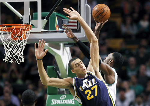 Utah Jazz center Rudy Gobert (27) is cleared out by Boston Celtics power forward Jeff Green, right, as he shoots during the first quarter of an NBA basketball game in Boston, Wednesday, Nov. 6, 2013. (AP Photo/Elise Amendola)