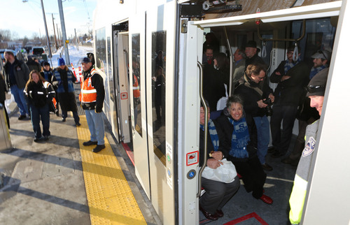 Francisco Kjolseth  |  The Salt Lake Tribune
People load up for a ride following grand opening ceremonies of the new Sugar House Streetcar on Thursday, Dec. 5, 2013. The Streetcar opens to the public on Saturday.