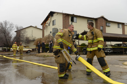 Leah Hogsten  |  The Salt Lake Tribune
Roy firefighters cleanup the scene of an apartment fire that damaged six units and displaced 12-18 people, Wednesday, March 26, 2014 in Roy. Over 30 firefighters from Roy and five surrounding cities assisted in putting out the blaze that began shortly before 8am and spread quickly due to two propane tank explosions.