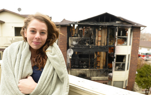 Leah Hogsten  |  The Salt Lake Tribune
"I'm glad no one got hurt," said Kylee Decker, 20, who saw the fire on the middle apartment deck across from her apartment, called 911 and went to alert her neighbors to leave their homes. Roy firefighters cleanup the scene of an apartment fire that damaged six units and displaced 12-18 people, Wednesday, March 26, 2014 in Roy. Over 30 firefighters from Roy and five surrounding cities assisted in putting out the blaze that began shortly before 8am and spread quickly due to two propane tank explosions.