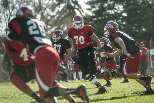 Chris Detrick  |  The Salt Lake Tribune
Utah's Jackson Barton, center, runs drills during a practice at the field west of the Spence & Cleone Eccles Football Center Wednesday March 26, 2014.