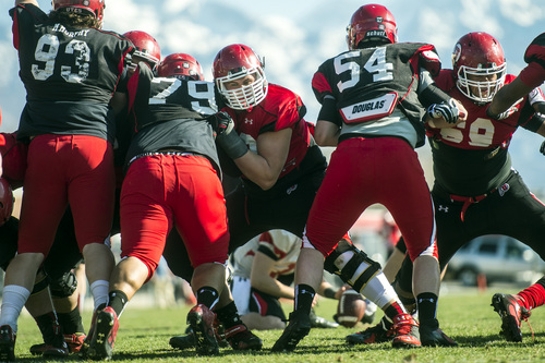 Chris Detrick  |  The Salt Lake Tribune
Utah's Jackson Barton runs drills against Likio Pope (79) and Isaac Asiata (54) during a practice at the field west of the Spence & Cleone Eccles Football Center Wednesday March 26, 2014.