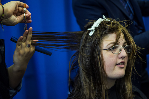 Chris Detrick  |  The Salt Lake Tribune
BYU junior Jessica Theriault has her hair cut by Marilyn Recinos at Brigham Young University's Wilkinson Student Center Terrace Wednesday March 26, 2014. The Center for Service and Learning at Brigham Young University  teamed up with Renaissance Academie Cosmetology and Esthetics for their biannual Locks of Love event. Female BYU students can donate their hair to disadvantaged children who suffer from medical-related hair loss.