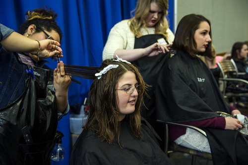 Chris Detrick  |  The Salt Lake Tribune
BYU junior Jessica Theriault, front, has her hair cut by Marilyn Recinos as BYU freshman Wynne Fuller has her hair cut by Bronwyn Haws at Brigham Young University's Wilkinson Student Center Terrace Wednesday March 26, 2014. The Center for Service and Learning at Brigham Young University  teamed up with Renaissance Academie Cosmetology and Esthetics for their biannual Locks of Love event. Female BYU students can donate their hair to disadvantaged children who suffer from medical-related hair loss.