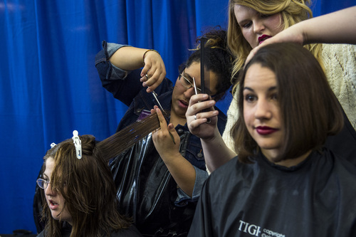 Chris Detrick  |  The Salt Lake Tribune
BYU junior Jessica Theriault, left, has her hair cut by Marilyn Recinos as BYU freshman Wynne Fuller has her hair cut by Bronwyn Haws at Brigham Young University's Wilkinson Student Center Terrace Wednesday March 26, 2014. The Center for Service and Learning at Brigham Young University  teamed up with Renaissance Academie Cosmetology and Esthetics for their biannual Locks of Love event. Female BYU students can donate their hair to disadvantaged children who suffer from medical-related hair loss.