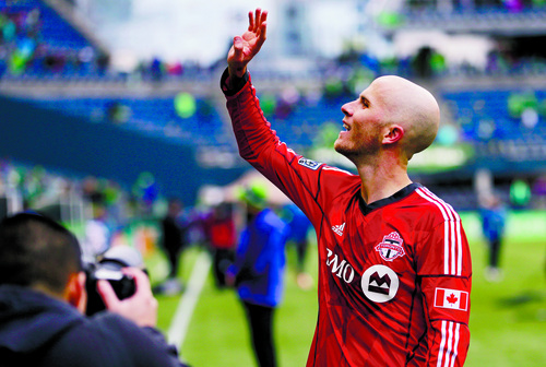 Toronto FC's Michael Bradley waves to the crowd after his team defeated the Seattle Sounders 2-1 in an MLS soccer match on Saturday, March 15, 2014, in Seattle. (AP Photo/Ted S. Warren)
