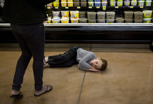 Kim Raff  |  The Salt Lake Tribune
Overwhelmed by the bright lights and loud noises at the grocery sore, James Turner curls up on the floor. The Stansbury Park boy has autism and his therapist (left) seizes upon the moment as a teaching opportunity. A new report says Utah's autism rate continues to be above average, but it's holding steady at about 2 percent of the population as the national rate rises.
