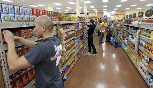 Al Hartmann  |  Tribune file photo
Trader Joe's employees stock shelves and organize the 12,700-square-foot store at 634 E. 400 South in Salt Lake City in 2012. The store is opening a second Utah location in Cottonwood Heights in 2015.