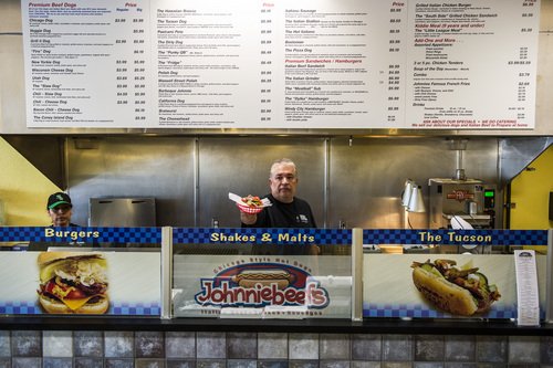 Chris Detrick  |  The Salt Lake Tribune
Owner John Carrsquilla serves a Chicago Dog ($3.99) with mustard, onions, green relish, cucumbers, tomatoes, sport peppers, pickle spear, and celery salt at Johnniebeefs in Cottonwood Heights.
