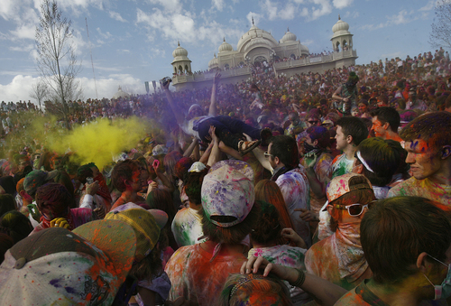 Scott Sommerdorf   |  The Salt Lake Tribune
"Crowd surfing" at the 2013 Festival of Colors - Holi Celebration - at the Krishna Temple in Spanish Fork, Saturday, March 30, 2013. The festival celebrates Holi, the announcement of the arrival of spring.