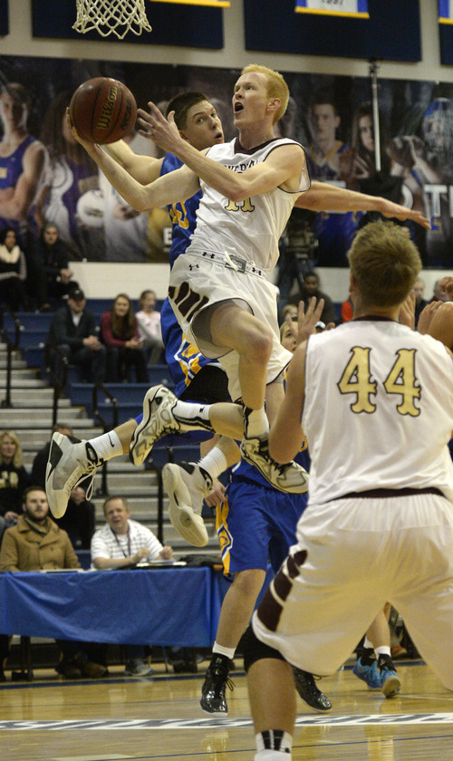 Rick Egan  | The Salt Lake Tribune 

TJ Haws goes in for two points for Lone Peak, as Dalton Nixon defends for the Tigers, in prep basketball action in the Great Western Shootout Showcase final game, Orem vs. Lone Peak, at Orem High School, Saturday, December 7, 2013.