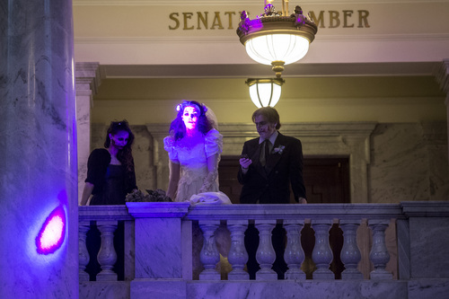 Chris Detrick  |  The Salt Lake Tribune
Zombie bride Marshay Norton, zombie groom Brandon Reamer and zombie bridesmaid Christie Karr watch the dancing outside of the Senate Chamber during the Zombie Invasion Ball Blood Carpet Event at the State Capitol Saturday March 29, 2014. Over 400 zombies, survivors and hunters attended the event which featured a zombies vs hunters dance-off, awards for the Zombie Ball Royalty and music by the Salt Lake Pops Quartet and DJ music by Chunga. Food was also donated to the Utah Food Bank.