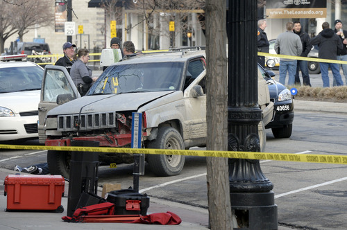 Al Hartmann  |  The Salt Lake Tribune
Salt Lake Police investigate the scene at 300 South and West Temple Friday morning March 28 where there was an officer involved shooting. Two officers were wounded and the suspect was killed.  Suspect was driving the SUV.