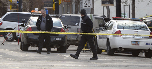 Al Hartmann  |  The Salt Lake Tribune
Salt Lake Police investigate the scene at 300 South and West Temple Friday morning March 28 where there was an officer involved shooting. Two officers were wounded and the suspect was killed.