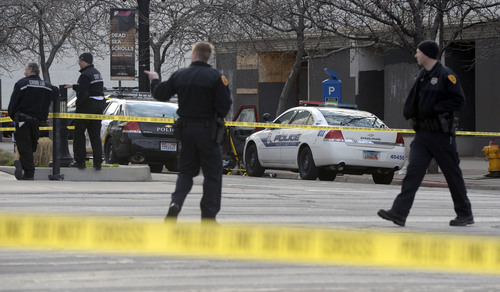 Al Hartmann  |  The Salt Lake Tribune
Salt Lake Police investigate the scene at 300 South and West Temple Friday morning March 28 where there was an officer involved shooting. Two officers were wounded and the suspect was killed.