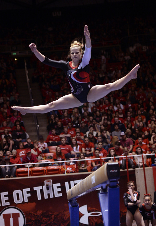 Al Hartmann  |  The Salt Lake Tribune 
University of Utah's Tory Wilson gets high altitude over the beam during her routine in a gymnastics meet against the University of Washington at the Huntsman Center Friday February 28.