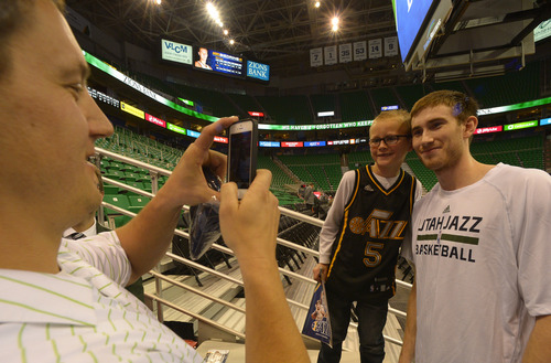 Rick Egan  | The Salt Lake Tribune 

Ted Stosich takes a shot of his son Sawyer Stosich 9, with Gordon Hayward, before the Hawks vs.The Utah Jazz game at EnergySolutions Arena, Monday, March 10, 2014.