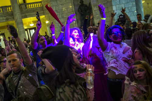 Chris Detrick  |  The Salt Lake Tribune
Zombies and hunters dance during the Zombie Invasion Ball Blood Carpet Event at the State Capitol Saturday March 29, 2014. Over 400 zombies, survivors and hunters attended the event which featured a zombies vs hunters dance-off, awards for the Zombie Ball Royalty and music by the Salt Lake Pops Quartet and DJ music by Chunga. Food was also donated to the Utah Food Bank.