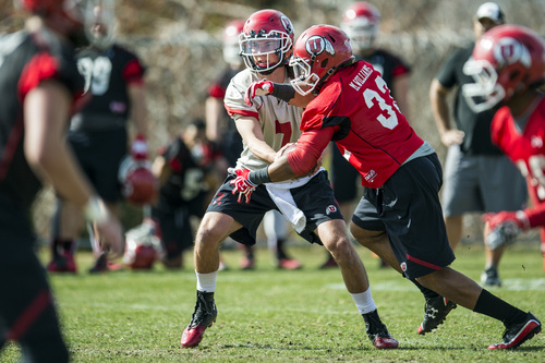 Chris Detrick  |  The Salt Lake Tribune
Utah quarterback Travis Wilson hands off the ball to Marcus Sanders-Williams during a practice at Spence and Cleone Eccles Football Center Thursday March 20, 2014.