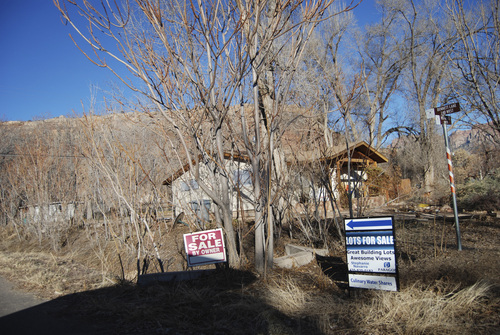 Brian Maffly | The Salt Lake Tribune
Undeveloped lots were for sale in Rockville in January, some near the base of a precipice that ocassionally drops sandstone boulders into the neighborhood on the north side of State Route 9.