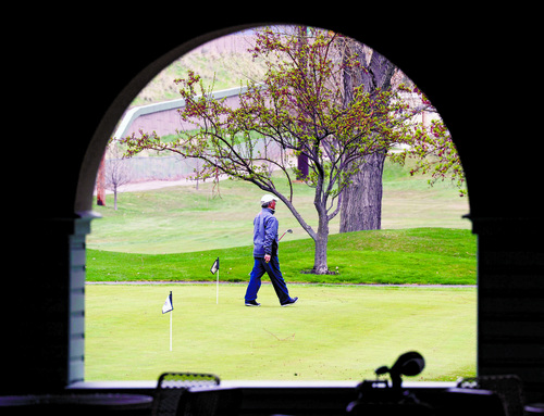 Al Hartmann  |  The Salt Lake Tribune
Golfer warms up on chipping green at Forestdale Golf course in Salt Lake City Monday April 1 waiting for the hail storm to pass.