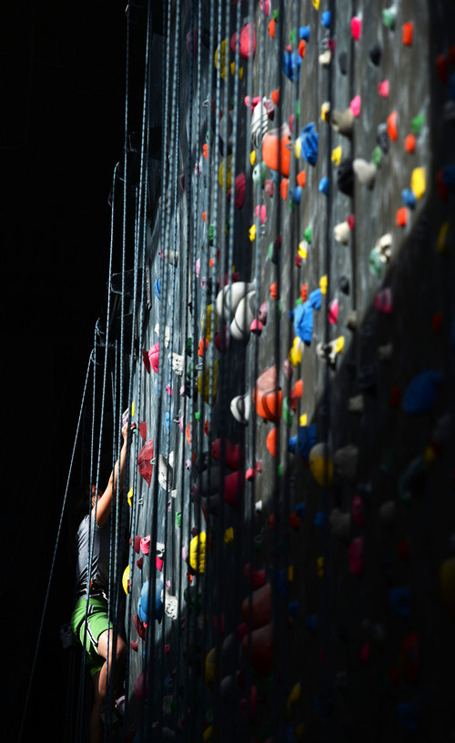 Steve Griffin  |  The Salt Lake Tribune
Autumn Schley climbs into a section of wall that is lit by the sun at Momentum indoor climbing gym in Sandy, Utah Wednesday, April 2, 2014.