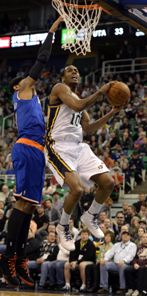 Rick Egan  |  The Salt Lake Tribune

Utah Jazz forward Marvin Williams (2) Utah Jazz guard Alec Burks (10) goes upper the hoop for two points, as Carmelo Anthony (7) defends, in NBA action, Utah Jazz vs. the New York Knicks, at EnergySolutions arena, Monday, March 31, 2014