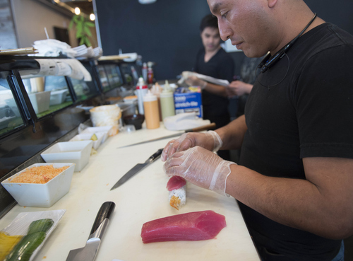 Keith Johnson | The Salt Lake Tribune

Osmar Lopez prepares sushi at Fat Fish, a new sushi and pho restaurant  in West Valley City, March 24, 2014.