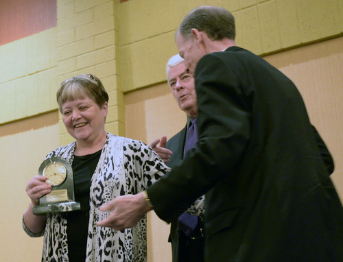 Al Hartmann  |  The Salt Lake Tribune
St. Joseph Catholic Elementary School Principal Nancy Essary, left,  accepts award at the annual Dream Builder's Breakfast in Ogden April 2.  Executive Director of Catholic Catholic Community Services of Utah Brad Drake and Most Reverend Bishop John C.  Wester, right. Catholic Community Services (CCS) hosted the annual Dream Builder's Breakfast; honoring those in the community making a difference. Funds raised at the breakfast will help in establishing a new child hunger program called Bridging the Gap.
