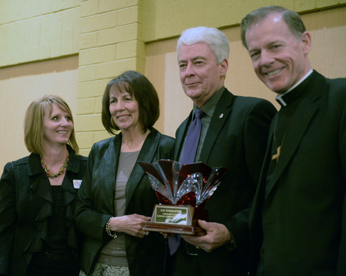 Al Hartmann  |  The Salt Lake Tribune
Marcie Valdez, Northern Utah Director of Catholic Community Services, left, stands with Weber County Commissioner Jan M. Zogmaister who accepts award at the annual Dream Builder's Breakfast in Ogden April 2.   Catholic Community Services Executive Director Brad Drake and Most Reverend Bishop John C.  Wester, right.  Catholic Community Services (CCS) hosted the annual Dream Builderís Breakfast; honoring those in the community making a difference. Funds raised at the breakfast will help in establishing a new child hunger program called Bridging the Gap.