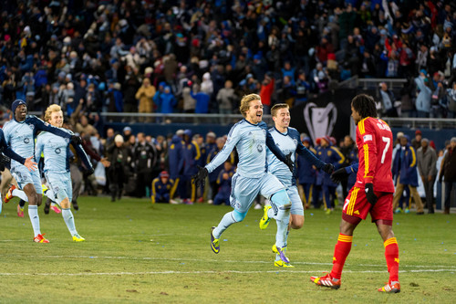 Trent Nelson  |  The Salt Lake Tribune
Sporting KC players celebrate, running past Real Salt Lake's Lovel Palmer (7) as Real Salt Lake faces Sporting KC in the MLS Cup Final at Sporting Park in Kansas City, Saturday December 7, 2013.