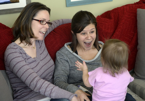 Al Hartmann  |  The Salt Lake Tribune 
Kimberly, left, and Amber Leary play "Itsy-Bitsy Spider" with their 15-month-old daughter Thursday, February 2,7 at their home. They are among an unknown number of gay couples in Utah whose efforts to pursue second-parent adoptions have been thwarted by a stay of a court decision overturning the same-sex marriage ban and intervention by the Utah Attorney General's Office.