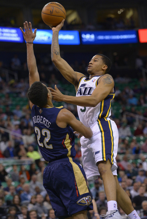 Leah Hogsten  |  The Salt Lake Tribune
Utah Jazz guard Trey Burke (3) fires one over the hands of New Orleans Pelicans guard Brian Roberts (22) during the first half of their game Friday, April 4, 2014 at Energy Solutions Arena.