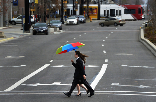 Scott Sommerdorf   |  The Salt Lake Tribune
A couple walks under an umbrella toward the LDS conference center as they pass 200 South near the Salt Palace Convention Center, Saturday, April 5, 2014.