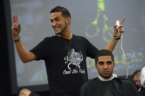 Scott Sommerdorf   |  The Salt Lake Tribune
Joseph Lucero reacts to his introduction as he cuts the hair of Arjan Jahromi during the "Best Overall men's cut and style" competition at the Golden Shear Hair & Beauty Show. The show showcased the skills of professionals from Salt Lake County and surrounding areas. It is sponsored by the Journeymens Barber League, Saturday, April 5, 2014.