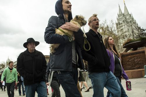 Chris Detrick  |  The Salt Lake Tribune
John Landfair and his dog Hazel, along with other atheists of Utah, ex-Mormons and disaffected, disbelieving Latter-day Saints march around Temple Square after the morning session of the 184th Annual General Conference of The Church of Jesus Christ of Latter-day Saints Sunday April 6, 2014. The American Atheists group is holding its national convention in Salt Lake City in two weeks, April 17-20.