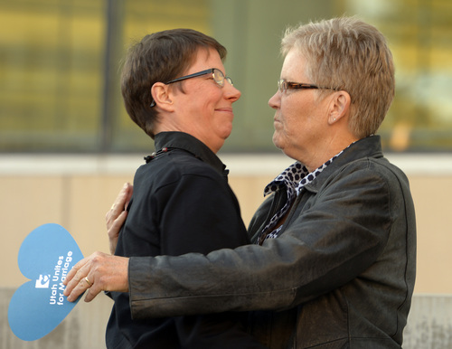 Rick Egan  |  The Salt Lake Tribune

Plantiffs, Kody Partridge and Laurie Wood hug at the Utah Unites for Marriage "send-off" event Monday night at Library Square, Monday, April 7, 2014