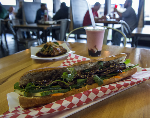 Keith Johnson | The Salt Lake Tribune

The Kalki beef banh mi sandwich with basil wings and a boba smoothie in the background at the Noodle and Chopstick restaurant in West Valley City.