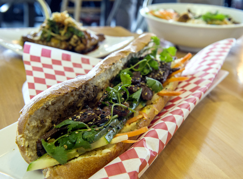 Keith Johnson | The Salt Lake Tribune

The Kalki beef banh mi sandwich with basil wings and a vermicelli bowl in the background at the Noodle and Chopstick restaurant in West Valley City.