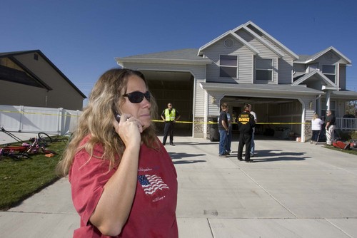 Paul Fraughton  |  The Salt Lake Tribune
Distraught Woods Cross resident Linda Wood makes phone calls while she stands outside her home that was condemned as a result of damage sustained in an explosion at the Silver Eagle Refinery on  Wednesday, Nov. 4, 2009.