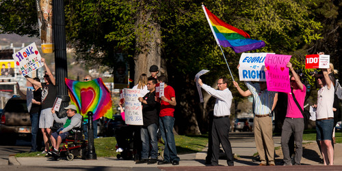 Trent Nelson  |  The Salt Lake Tribune
Citizens show their support of marriage equality, holding signs and waving to traffic in front of the City & County Building in Salt Lake City, Thursday April 10, 2014.