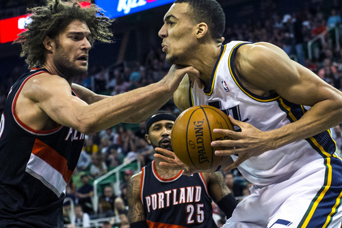 Chris Detrick  |  The Salt Lake Tribune
Portland Trail Blazers center Robin Lopez (42) hits Utah Jazz center Rudy Gobert (27) in the neck during the game at EnergySolutions Arena Friday April 11, 2014. Portland is winning the game 53-51 at halftime.