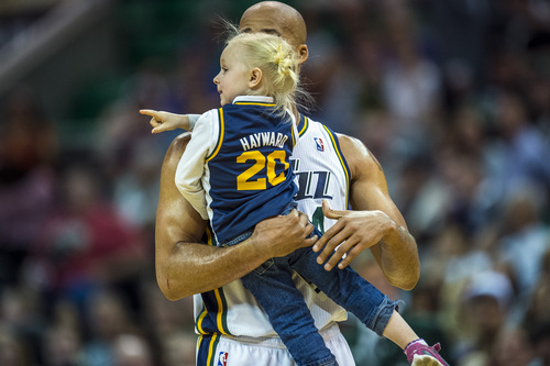 Chris Detrick  |  The Salt Lake Tribune
Utah Jazz forward Richard Jefferson (24) carries a young girl off of the court during the game at EnergySolutions Arena Saturday April 12, 2014. Portland is winning the game 53-51 at halftime.