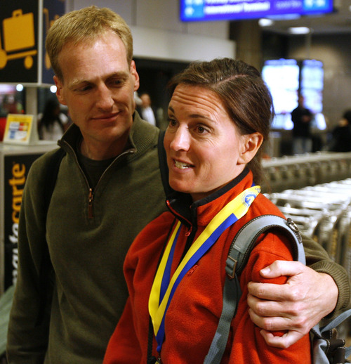 Rick Egan  | The Salt Lake Tribune 

Mike Davey hugs his wife Kellie Davey at the Salt Lake International Airport, after they returned from Boston Monday evening, April 15, 2013.  Kellie had just finished the Boston Marathon, when the explosions went off.