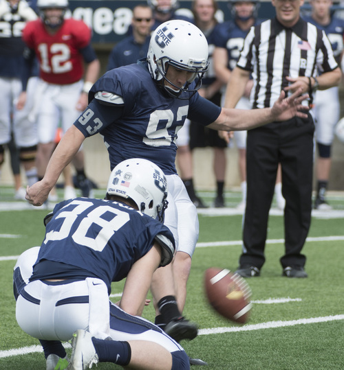 Rick Egan  |  The Salt Lake Tribune

Jaron Bentrude (38) holds the ball as Lucas Oja (93) kicks the game winning field goal, on the final play of the game, in the Utah State Aggie's final spring scrimmage, Saturday, April 12, 2014.