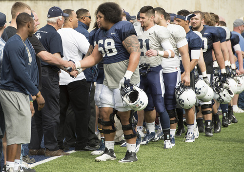 Rick Egan  |  The Salt Lake Tribune

Bill Vavau (68) leads the ground of Aggie football players as they shake hands with VIP's after the final Utah State spring scrimmage, Saturday, April 12, 2014.