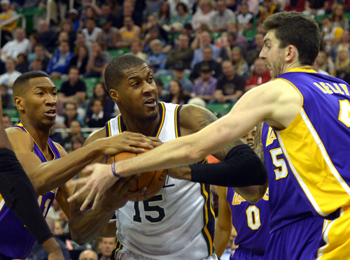 Rick Egan  |  The Salt Lake Tribune

Utah Jazz center Derrick Favors (15) trees to keep control of the ball, as he its triple teamed by Los Angeles Lakers forward Wesley Johnson (11), Los Angeles Lakers center Robert Sacre (50), and Los Angeles Lakers forward Ryan Kelly (4), in NBA action, The Utah Jazz vs. The Los Angeles Lakers, at EnergySolutions Arena, Monday, April 14, 2014